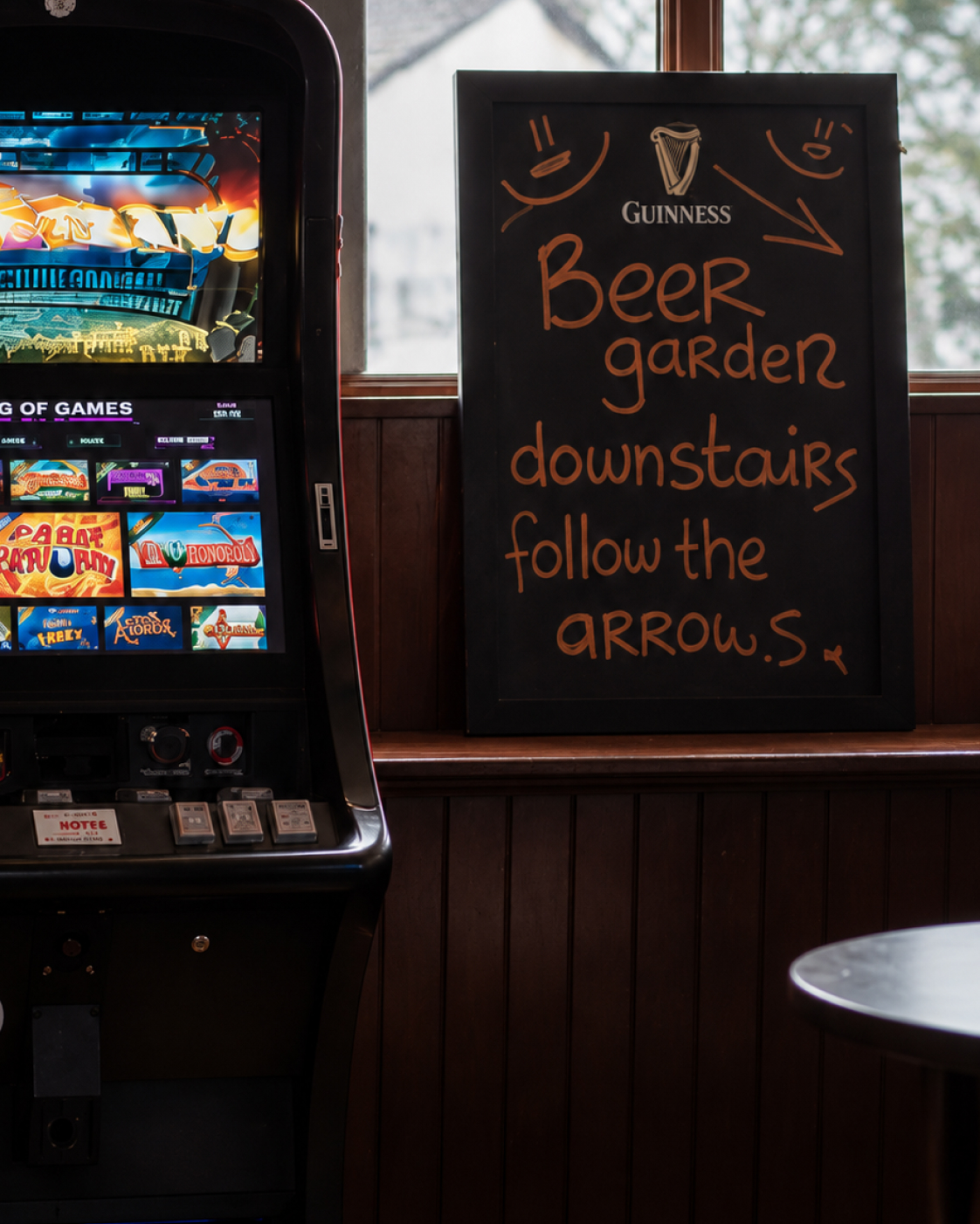 Beer garden direction sign beside a gaming machine at The Burgh Bar Dunoon