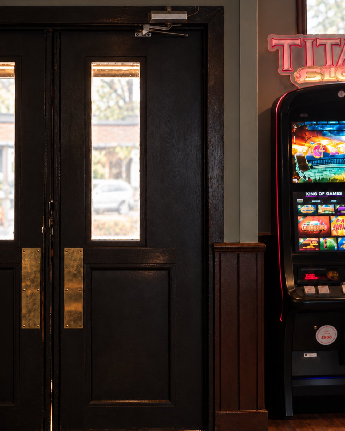 Pub entrance door and gaming machine inside The Burgh Bar Dunoon
