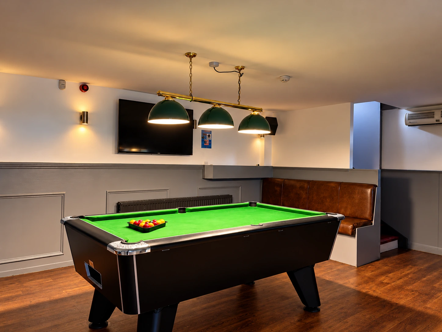 Pool table beneath pendant lights at The Burgh Bar Dunoon