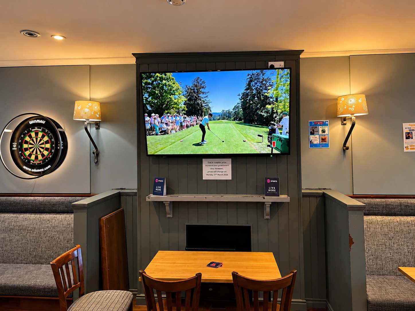 Sports shown on a large screen beside a dartboard at The Burgh Bar Dunoon