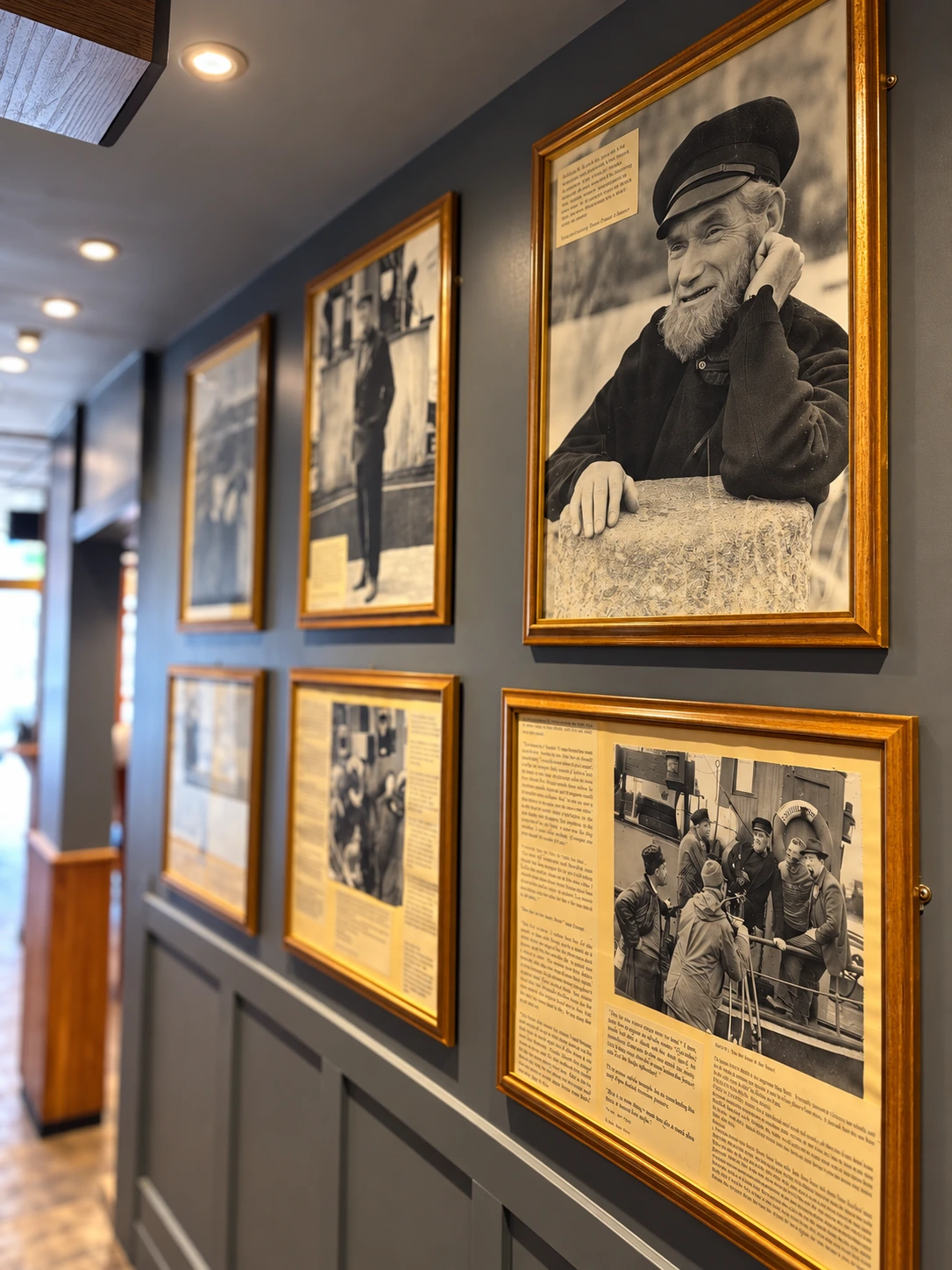 Framed maritime photographs displayed along a wall at The Burgh Bar Partick