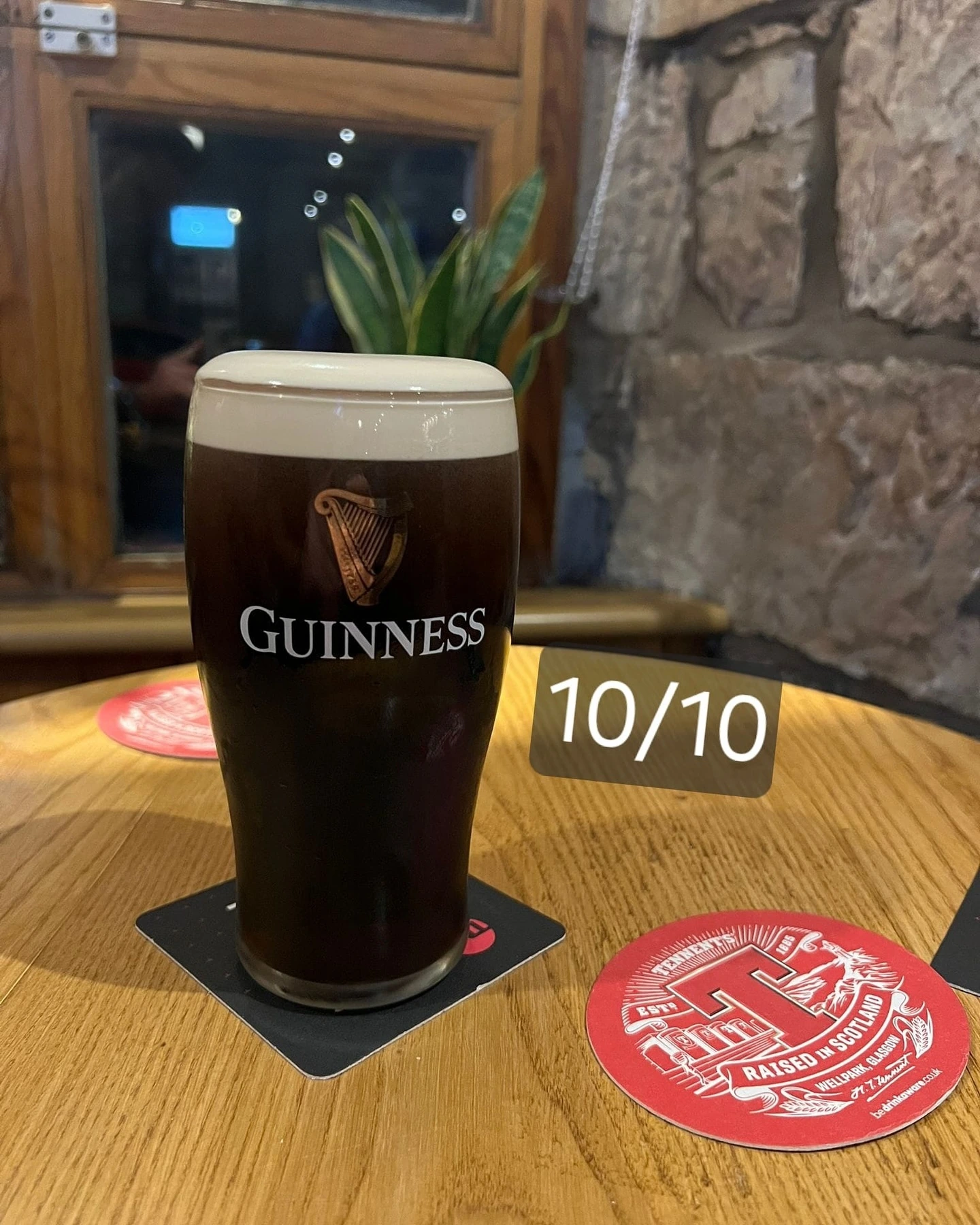 Pint of Guinness on a table at The Burgh Bar Partick