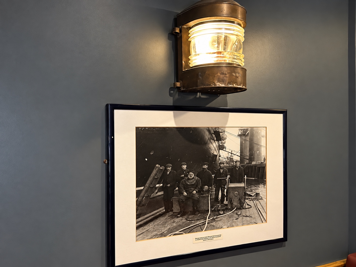 Framed historic photograph and wall light inside The Burgh Bar Partick