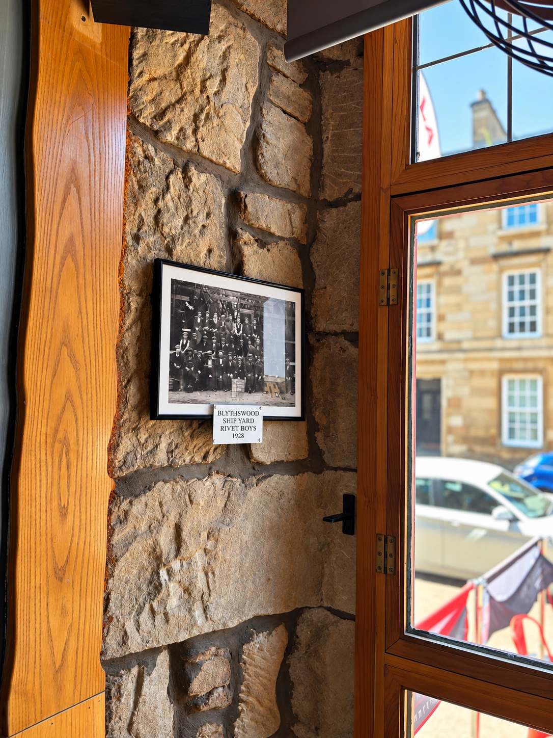 Historic framed photograph on a stone wall at The Burgh Bar Partick
