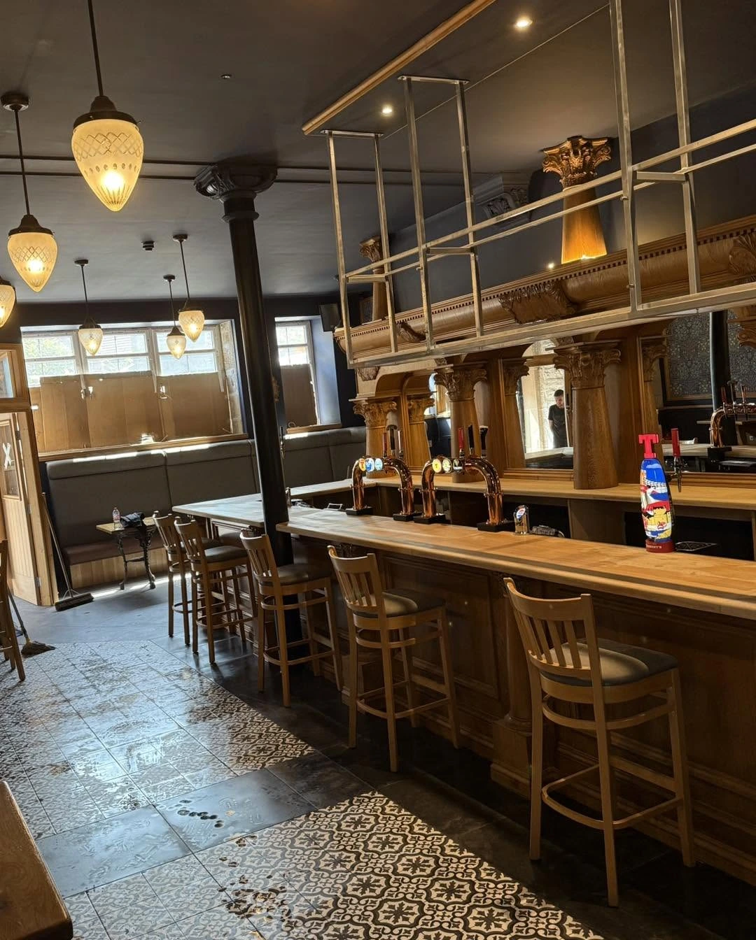 Timber bar, pendant lights and patterned floor tiles at Milne’s in Dunoon