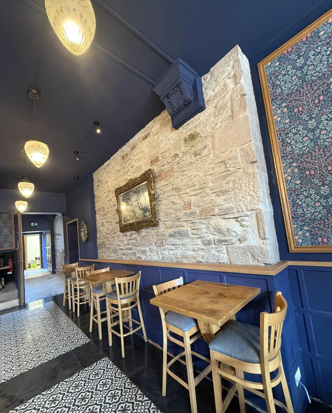 Stone wall and blue bench seating at Milne’s in Dunoon